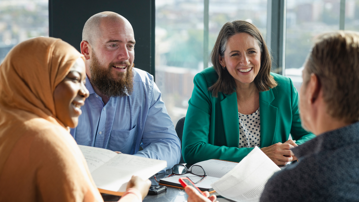 A team collaborating in a modern office, symbolizing a business that runs without the owner