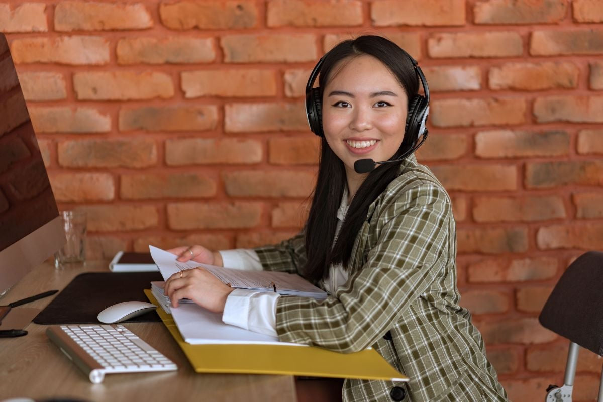 Event planning virtual assistant wearing a headset while reviewing documents